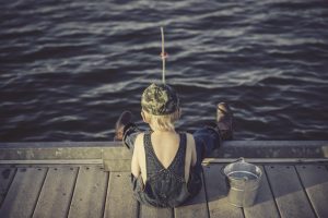 LIttle boy fishing on pier