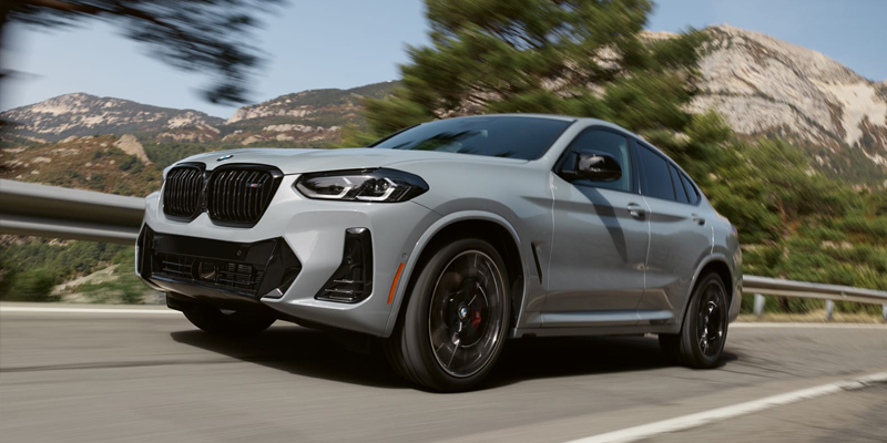 A BMW Certified Pre-Owned X4 driving on a mountain highway