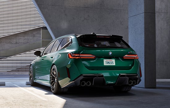 Green BMW M5 Touring parked in garage. | Tom Bush BMW Orange Park in Jacksonville FL