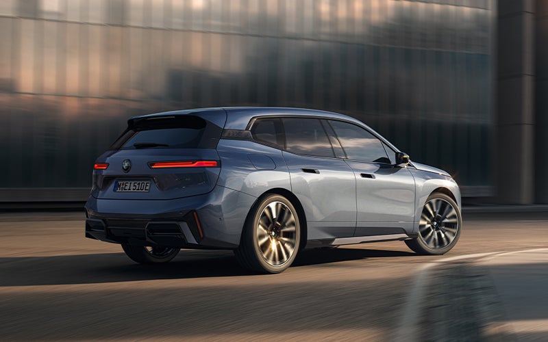 The BMW iX driving with the front wheel turned. | Tom Bush BMW Orange Park in Jacksonville FL